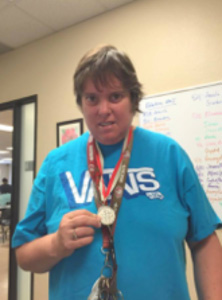 Debbie shows off one of her many sports medals